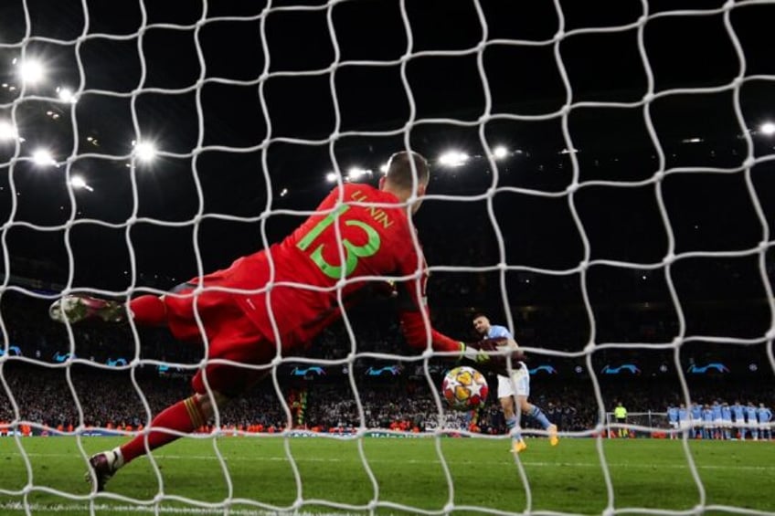 Real Madrid goalkeeper Andriy Lunin saving from Manchester City's Mateo Kovacic in the qua