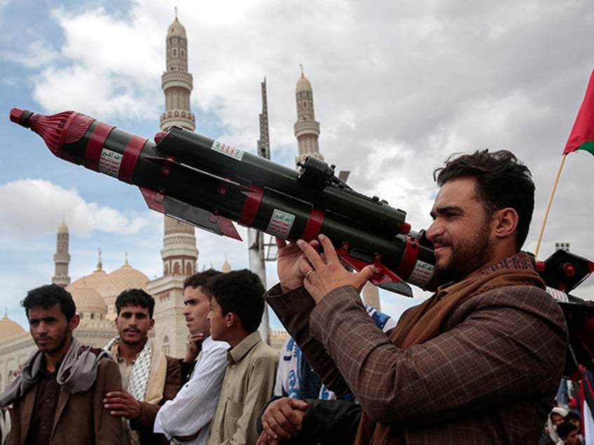 A Houthi supporter holds a mock missile during a protest marking Jerusalem Day in support of Palestinians in the Gaza Strip, in Sanaa, Yemen, Friday, April 5, 2024. (AP Photo/Osamah Abdulrahman)