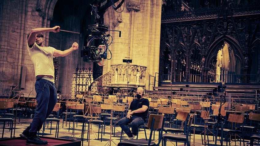 Bradley Cooper conducting on set