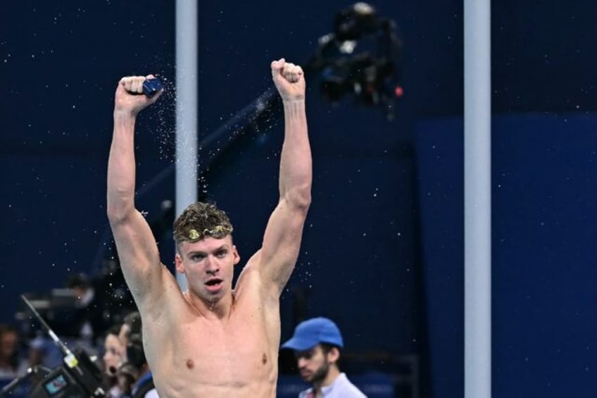 France's Leon Marchand celebrates after winning the final of the men's 200m breaststroke a