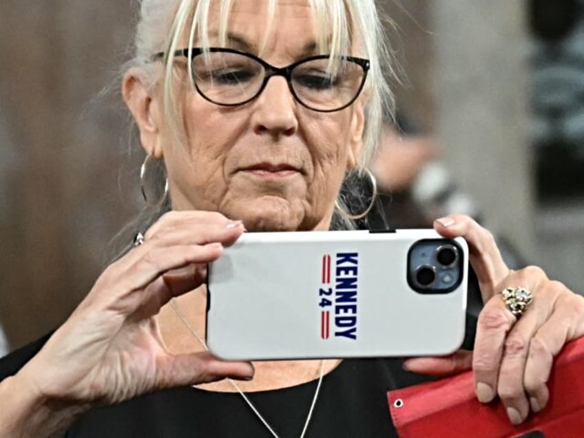 A supporter in the audience takes a picture before US Secretary of Health and Human Servic