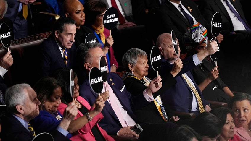 Democrats hold up signs