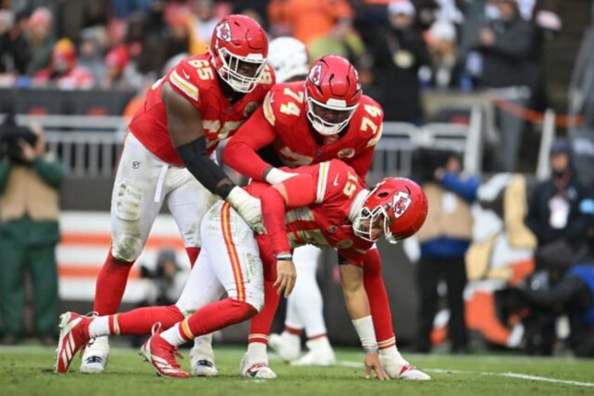 Kansas City Chiefs quarterback Patrick Mahomes is helped to his feet after a heavy hit in