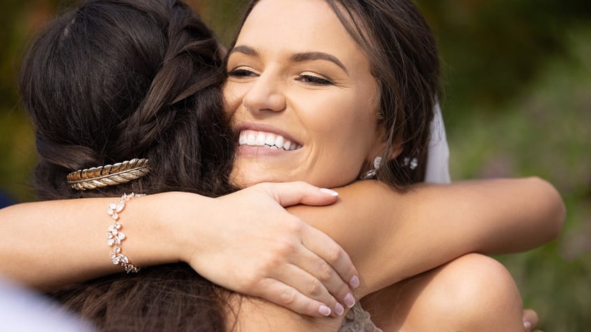 Bride hugs wedding guest