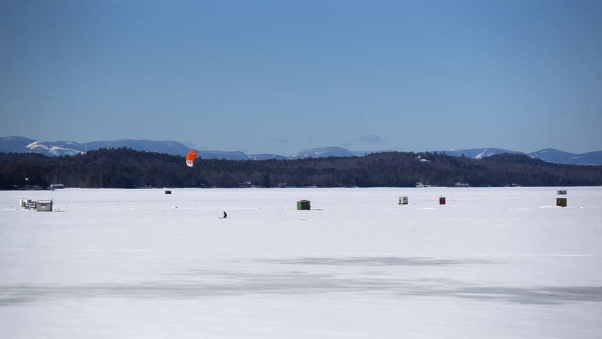 Wide shot of ice fishing sheds in Maine