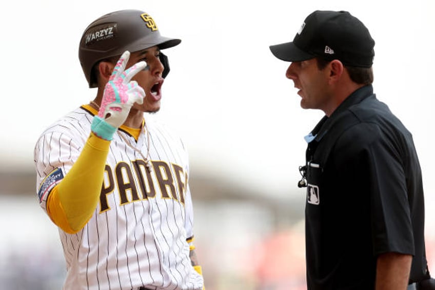 Manny Machado of the San Diego Padres argues with home plate umpire Pat Hoberg after striking out during the fifth inning of game two for the MLB...