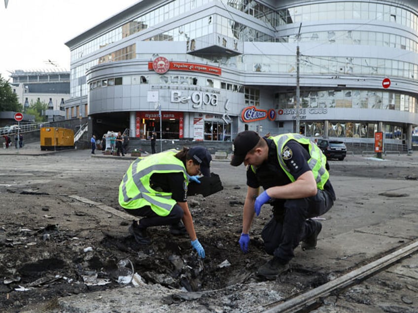 KYIV, UKRAINE - JULY 10: Police members collect remains of a Russian explosive device on t