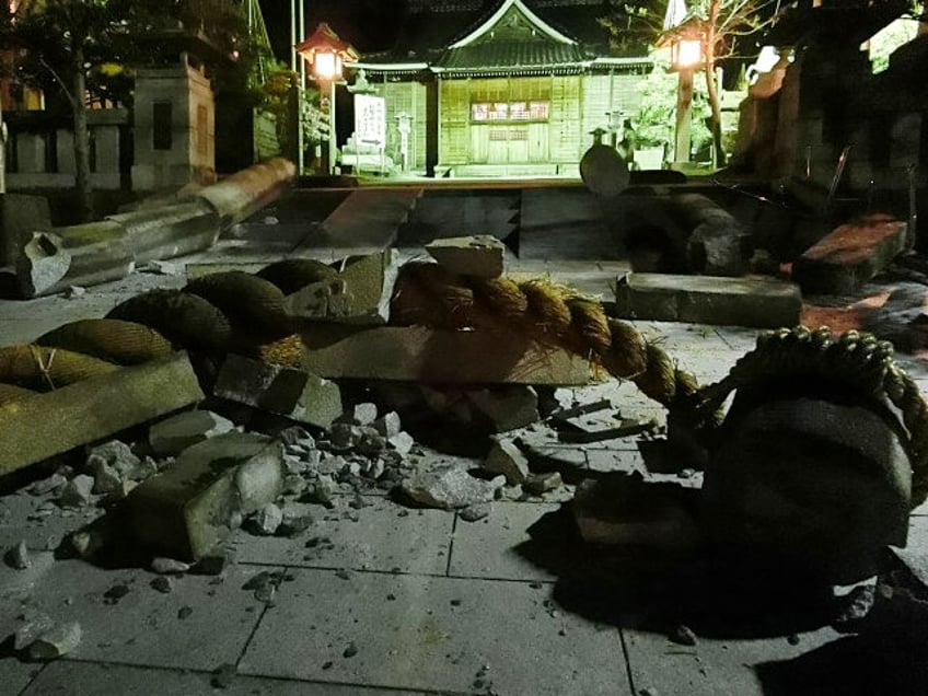 Debris is pictured in the grounds of the Onohiyoshi Shrine in the city of Kanazawa, Ishikawa prefecture, late on January 1, 2024, after it was damaged by a major 7.5 magnitude earthquake which struck the Noto region in Ishikawa prefecture earlier in the day. (STR/JIJI Press/AFP via Getty Images)