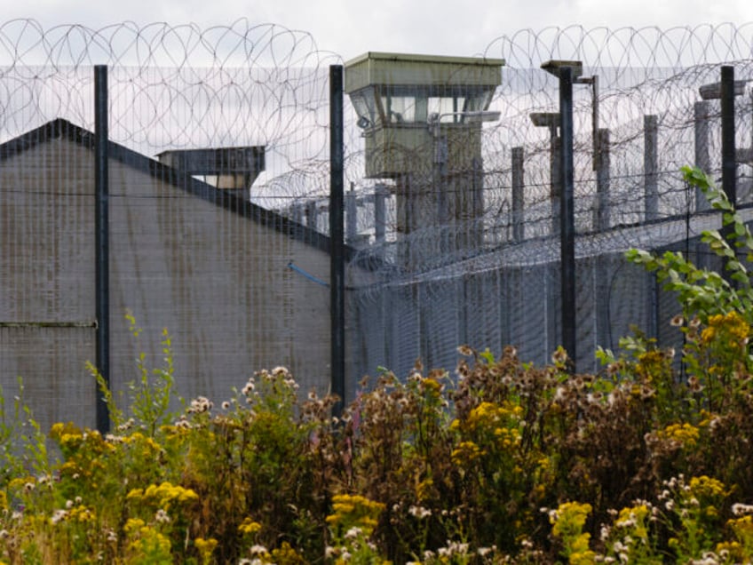 Watchtower behind barbed wire fences at a UK Prison