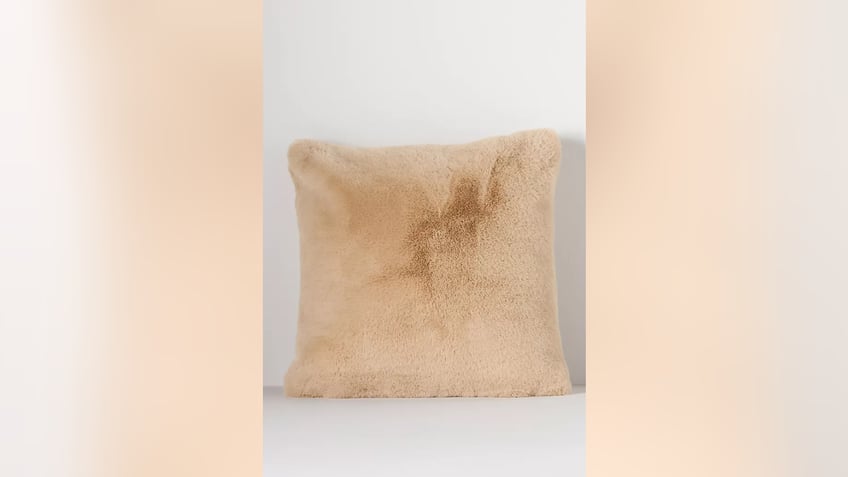A faux fur pillow is comfortable and stylish. 