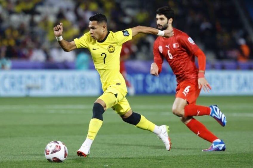 Malaysia's Faisal Halim (L) during the Qatar 2023 AFC Asian Cup Group E football match aga