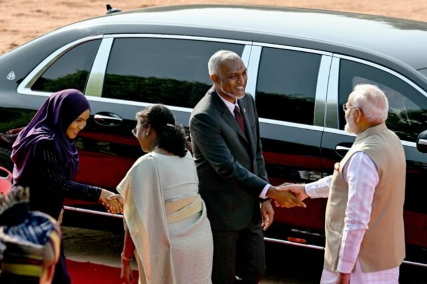 India's Prime Minister Narendra Modi (R) welcomes Maldives President Mohamed Muizzu during