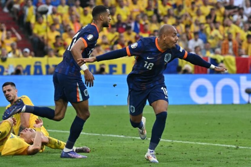 Netherlands forward Donyell Malen celebrates scoring against Romania