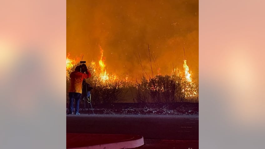 Fire in Malibu with a cameraman in the shot videoing the fire