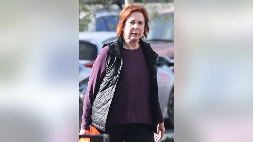 vicki lawrence walking through a parking lot and looking at the camera