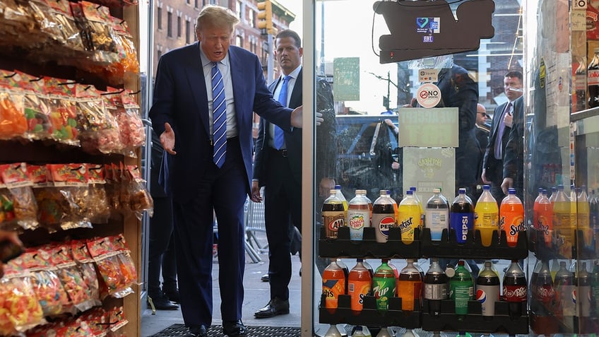 Former president Donald Trump reacts as he enters Sanaa convenience store, Tuesday, April 16, 2024, in New York. Fresh from a Manhattan courtroom, Donald Trump visited a New York bodega where a man was stabbed to death, a stark pivot for the former president as he juggles being a criminal defendant and the Republican challenger intent on blaming President Joe Biden for crime.