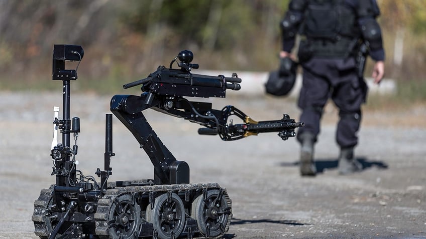 Police Swat Officer Using a Mechanical Arm Bomb Disposal Robot Unit