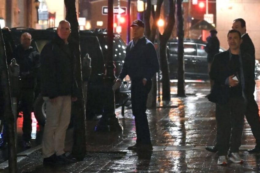 US President Joe Biden (C) looks on after a car hit a vechicle in the presidential motorcade as he left his campaign headquarters in Wilmington, Delaware on December 17, 2023