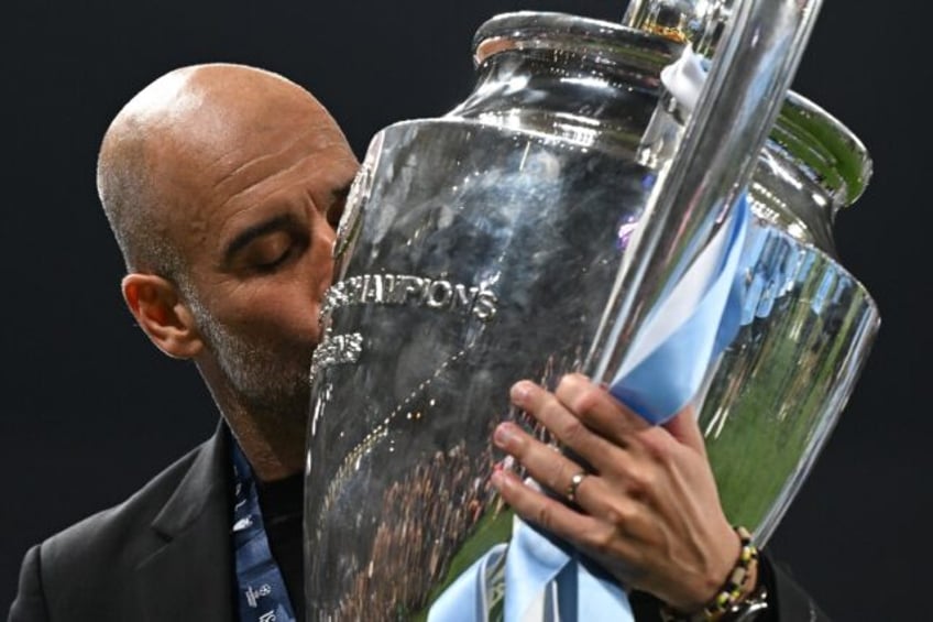 Pep Guardiola kisses the European Cup trophy after Manchester City's Champions League win