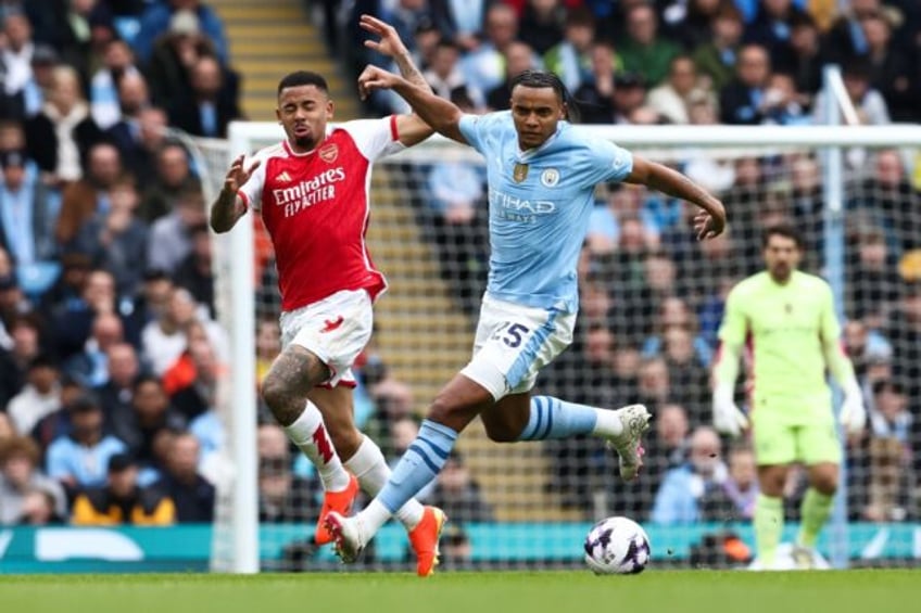 Yellow card complaint: Manchester City defender Manuel Akanji (R) in action against Arsena