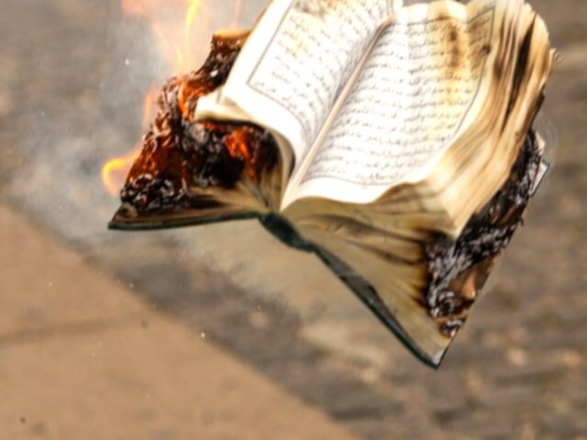 COPENHAGEN, DENMARK - JULY 28: A Quran is burned by an activist from the small right-wing