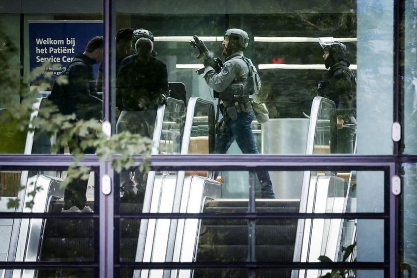 man in combat clothing shoots kills and starts fires at rotterdam hospital and residential