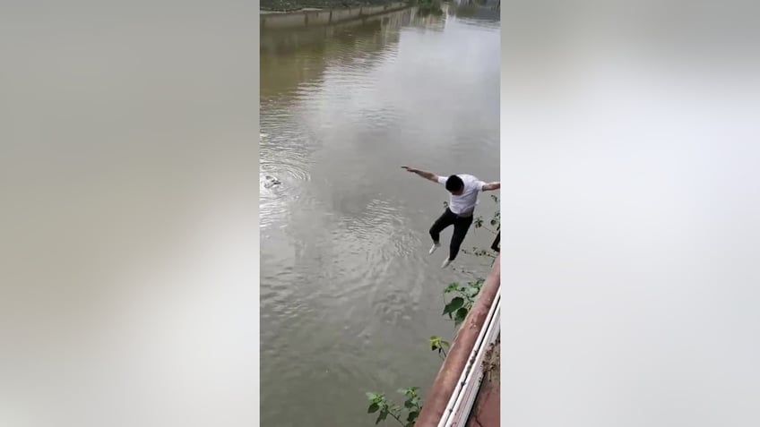 man jumps into fast flowing river to rescue little girl see the heroic moment