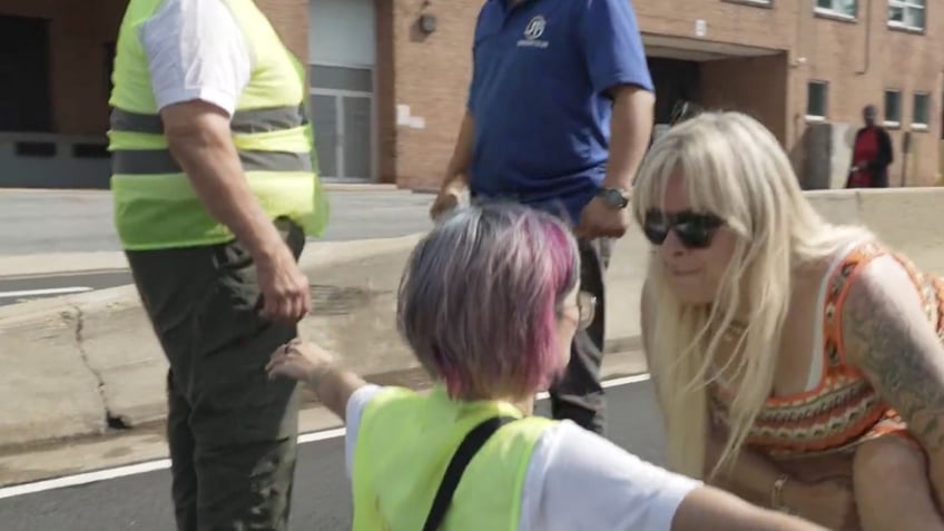 man lunges at climate activists blocking road on his way to work you motherf er