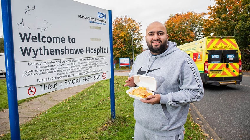 Omar Shafiq posing with food outside of a hospital.