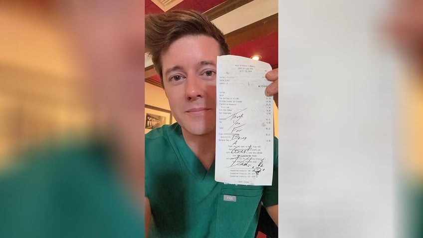 Man holding up note written on receipt.