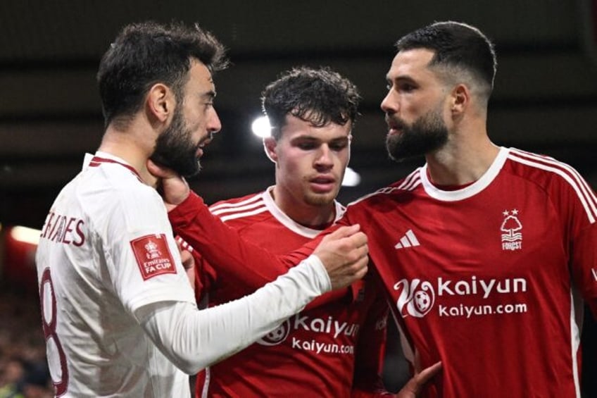 Nottingham Forest's Felipe (R) grabs Manchester United's Bruno Fernandes