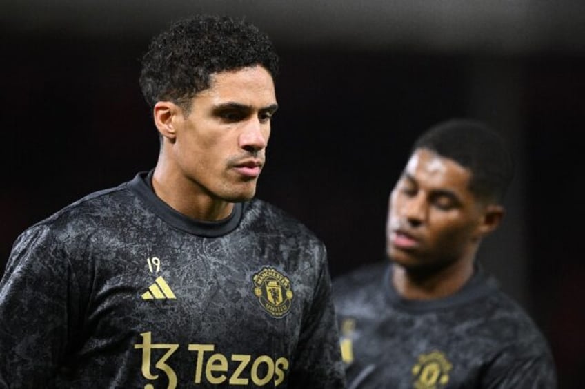 Manchester United and former Real Madrid defender Raphael Varane (L)