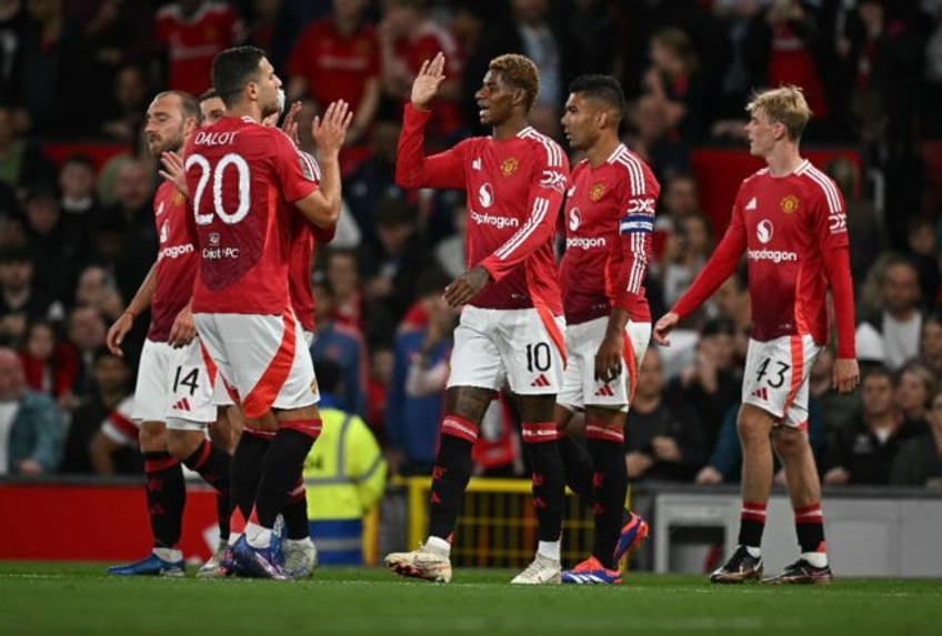 Manchester United's Marcus Rashford (C) celebrates scoring against Barnsley