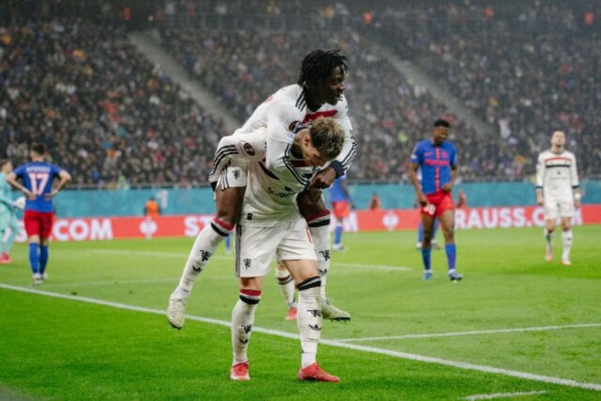 Manchester United's Kobbie Mainoo (top) celebrates scoring against FCSB