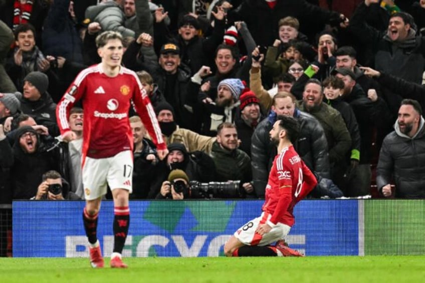 Bruno Fernandes (R) celebrates after scoring Manchester United's late winner against Range