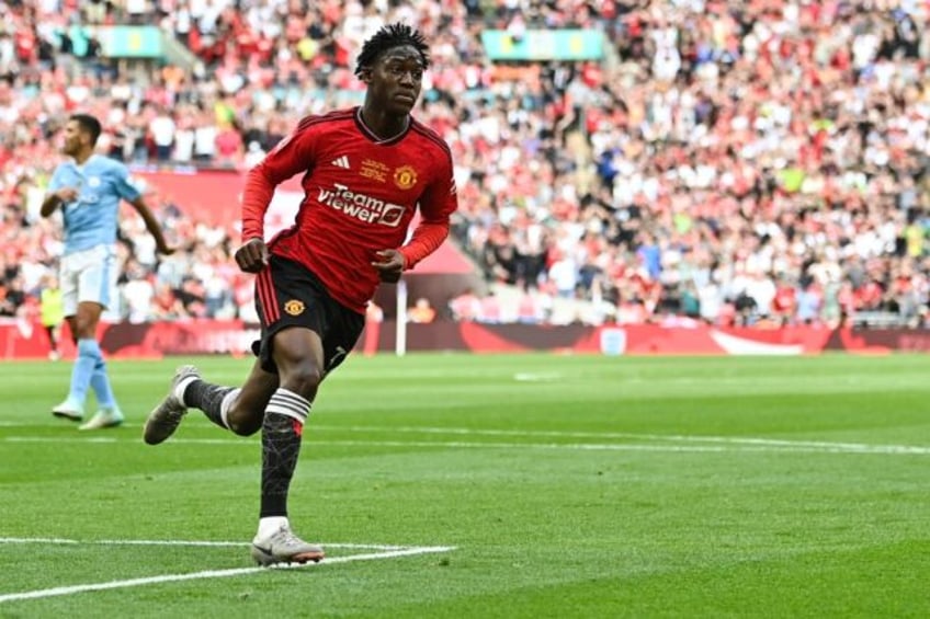 Manchester United's Kobbie Mainoo celebrates after scoring against Manchester City in the