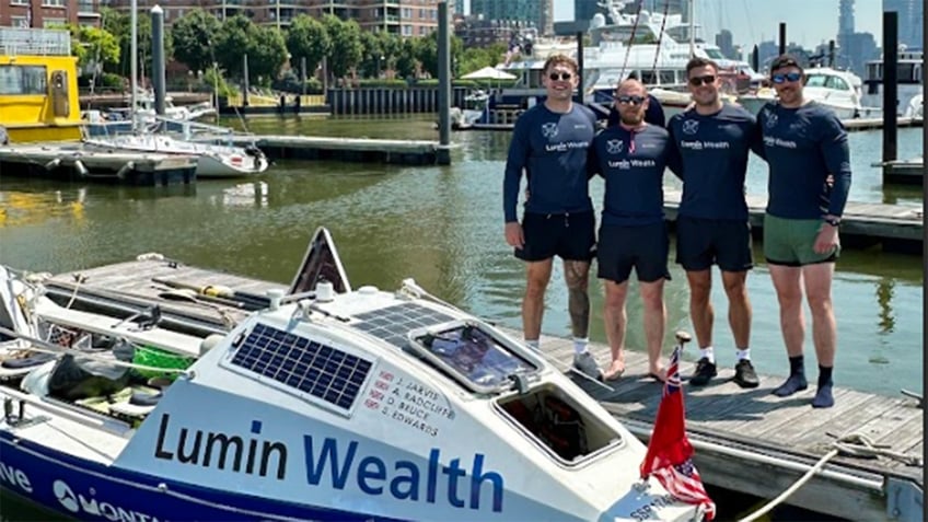 4-man rowing team pictured docked with their boat