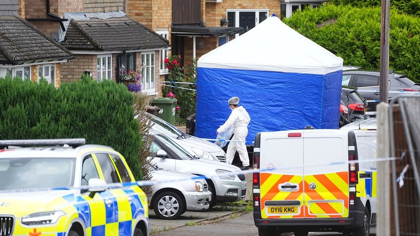 investigators outside homes in Bushey, England