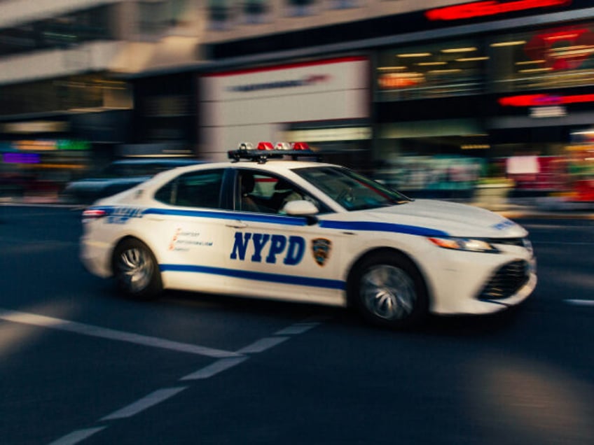 a police car driving down a city street