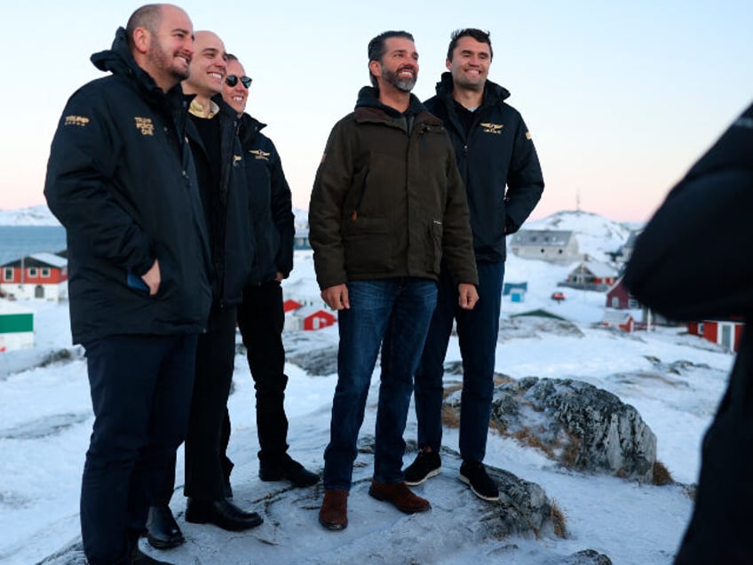 US businessman Donald Trump Jr. (2ndR) poses after arriving in Nuuk, Greenland on January