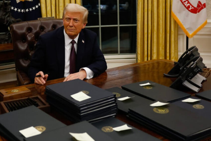 WASHINGTON, DC - JANUARY 20: President Donald Trump signs executive orders in the Oval Off