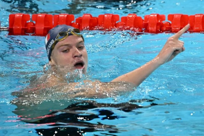 France's Leon Marchand celebrates after winning the final of the men's 400m individual med