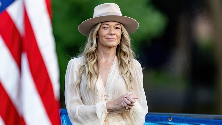 LeAnn Rimes posing in front of an American flag