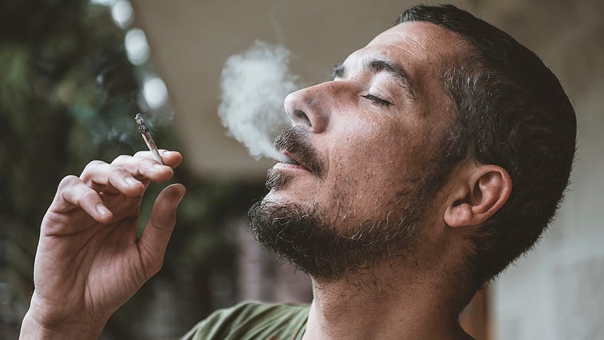 man smokes marijuana