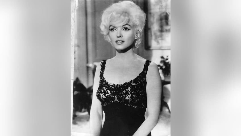 Marilyn Monroe wearing a black lace dress