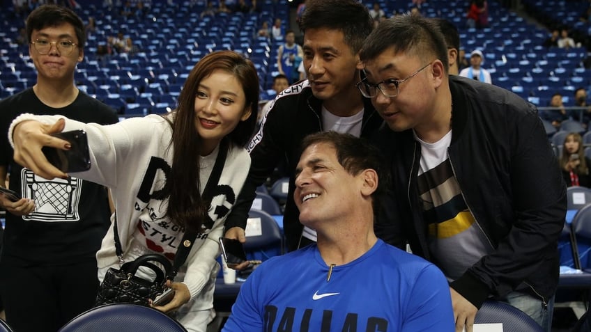 Dallas Mavericks owner Mark Cuban poses for a photo with fans prior to the game against the Philadelphia 76ers as part of the 2018 China Games on Oct. 5, 2018 at the Mercedes-Benz Arena in Shanghai.