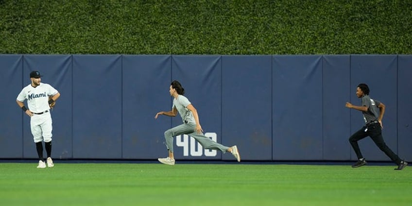 marlins field invader out maneuvers security in the outfield as team falls to phillies