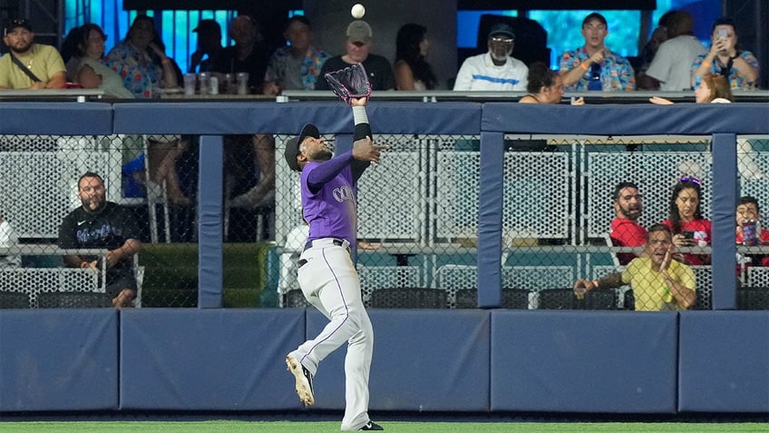 marlins snap eight game losing streak with extra innings victory over rockies