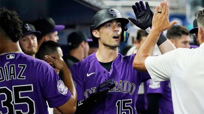 marlins snap eight game losing streak with extra innings victory over rockies