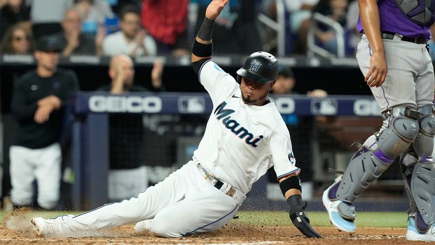 marlins snap eight game losing streak with extra innings victory over rockies